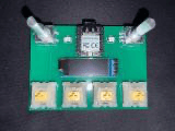 photo of the green macropad pcb with the xiao rp2040, oled, two rotary encoders and four switches mounted