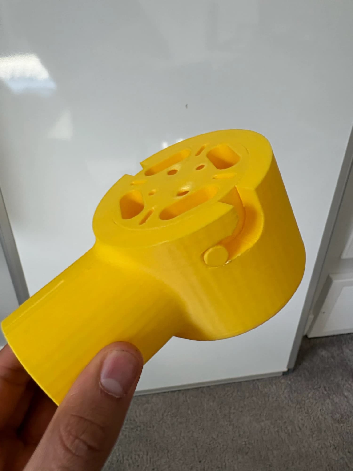 angled view of the yellow motor mount with the top plate twisted into the bayonet slot