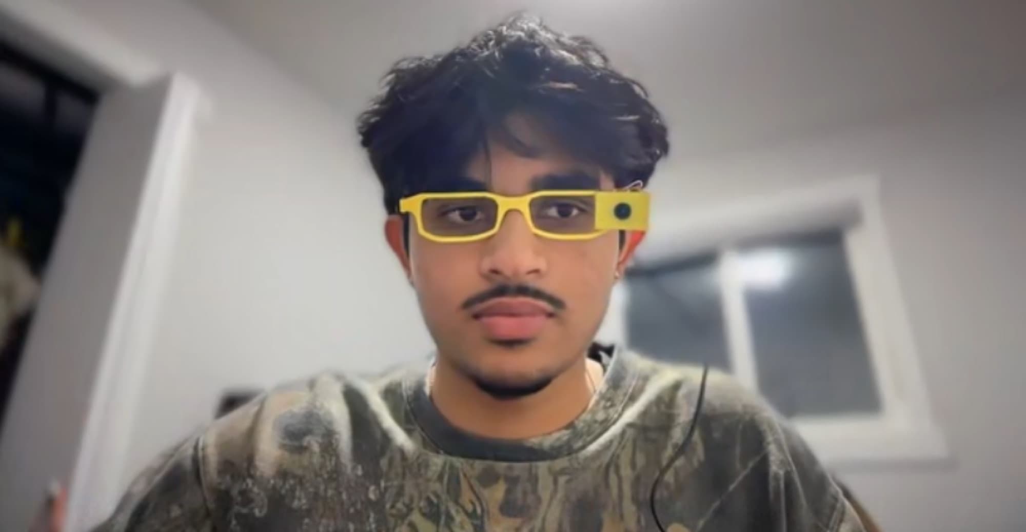wearing the yellow 3d-printed signbridge glasses with the camera on the frame